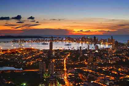 An aerial shot of Colombia with the sunset sky in the background