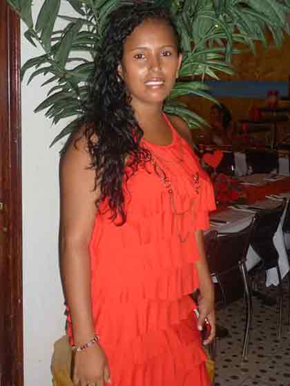 A photo of a Colombian woman in an orange dress